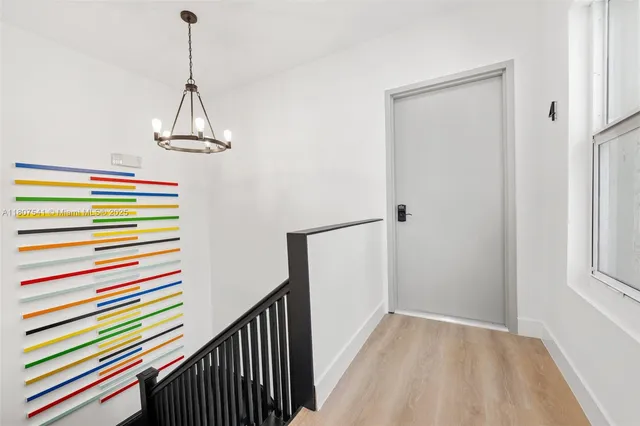 a view of a hallway with a chandelier