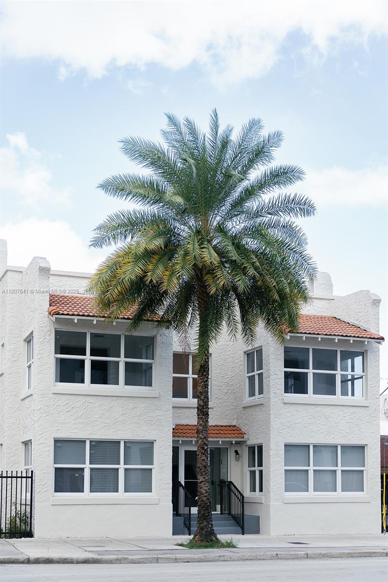 403 Southwest 12th Avenue, Unit 4 Miami, FL 33130 - Photo 23 of 24 a palm tree sitting in front of a building