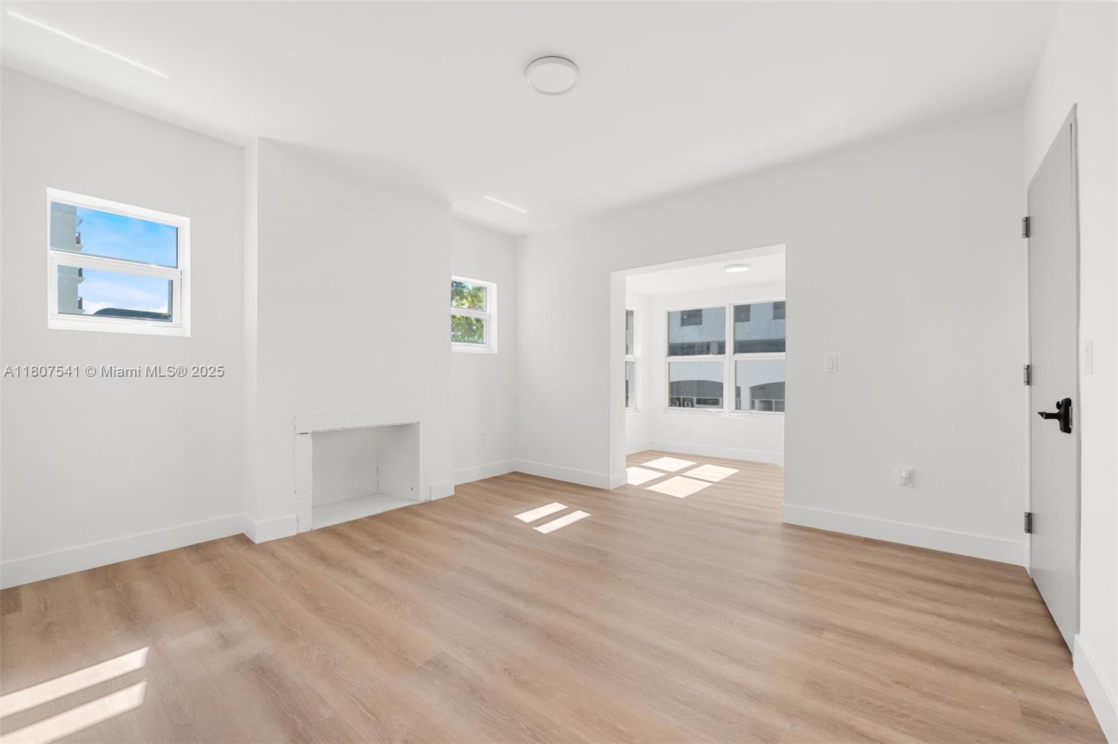 403 Southwest 12th Avenue, Unit 4 Miami, FL 33130 - Photo 9 of 24 a view of an empty room with wooden floor and windows