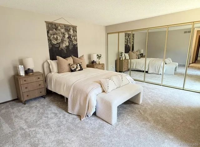 a bedroom with a bed and a night stand