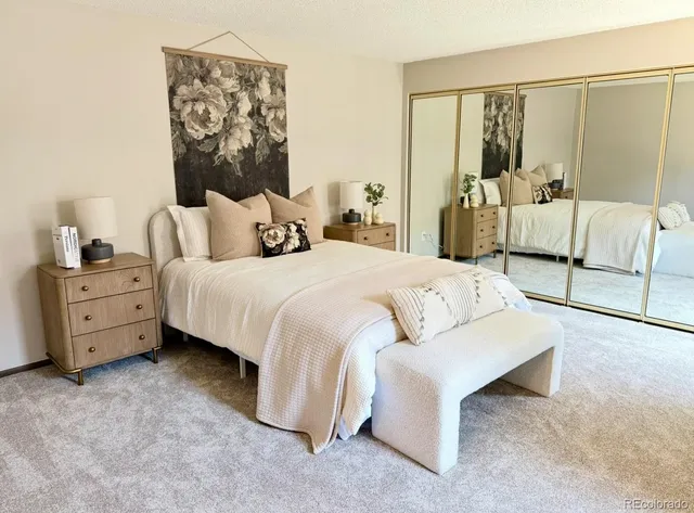 a bedroom with a bed and a night stand