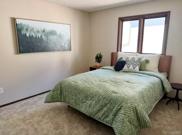 a bedroom with a bed and window