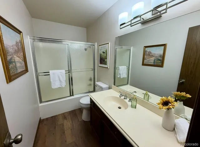 a bathroom with a sink a mirror and a toilet
