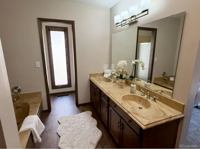 a bathroom with a sink vanity granite and a mirror