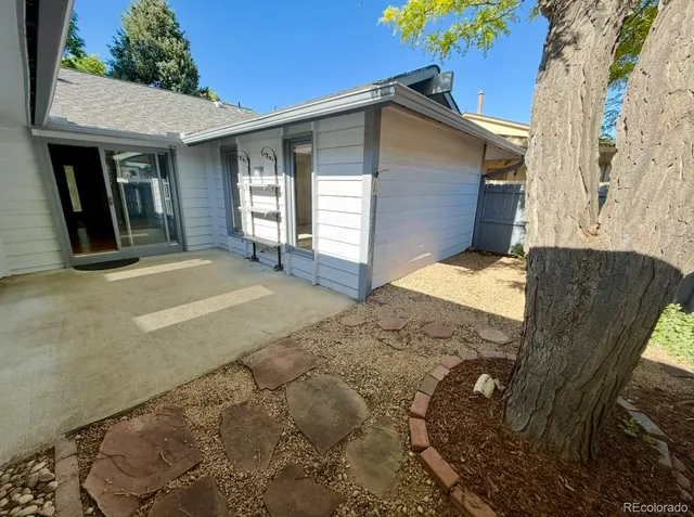 a view of backyard and wooden fence