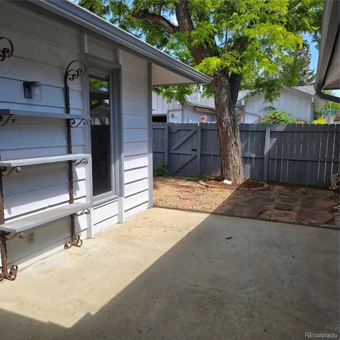 a view of a backyard with a tree