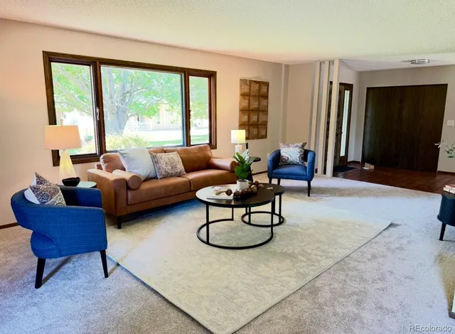 a living room with furniture and a large window