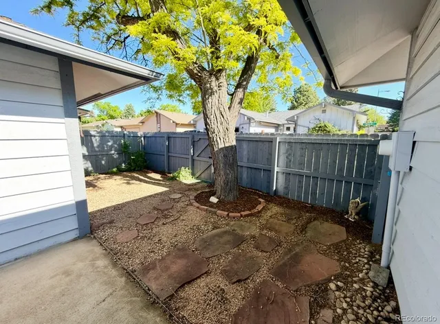 a sign that is sitting in front of a tree