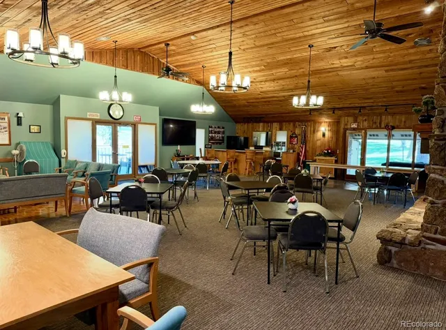 a living room with furniture a chandelier and large window