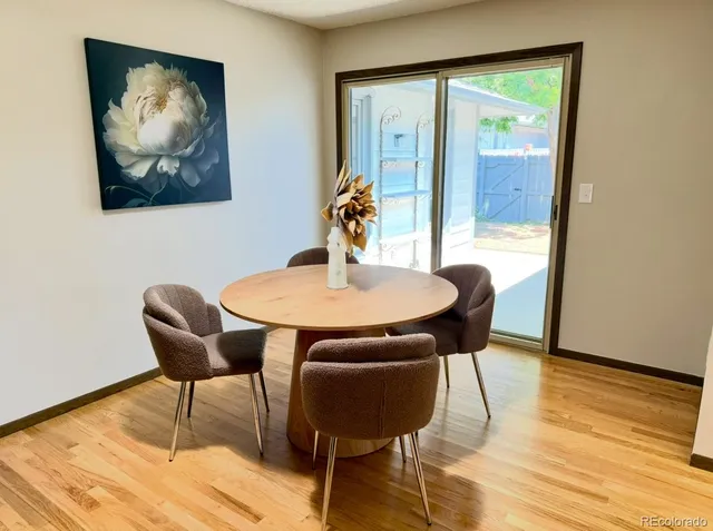 a dining room with furniture and wooden floor
