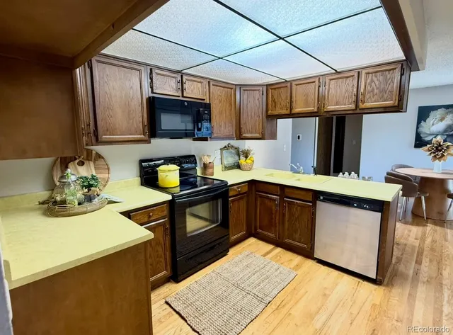 a kitchen with stainless steel appliances granite countertop a sink stove and microwave