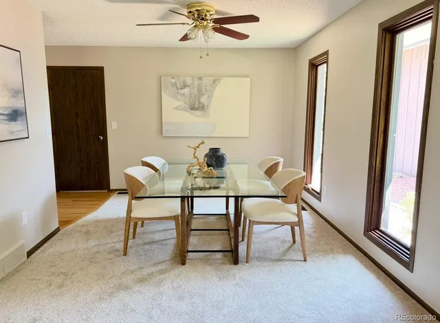 a dining room with furniture and window
