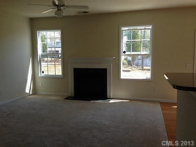 11406 Erwin Ridge Avenue Charlotte, NC 28213 - Photo 5 of 16 a living room with a fireplace and windows