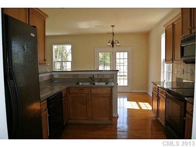 11406 Erwin Ridge Avenue Charlotte, NC 28213 - Photo 6 of 16 a kitchen with a refrigerator and a sink