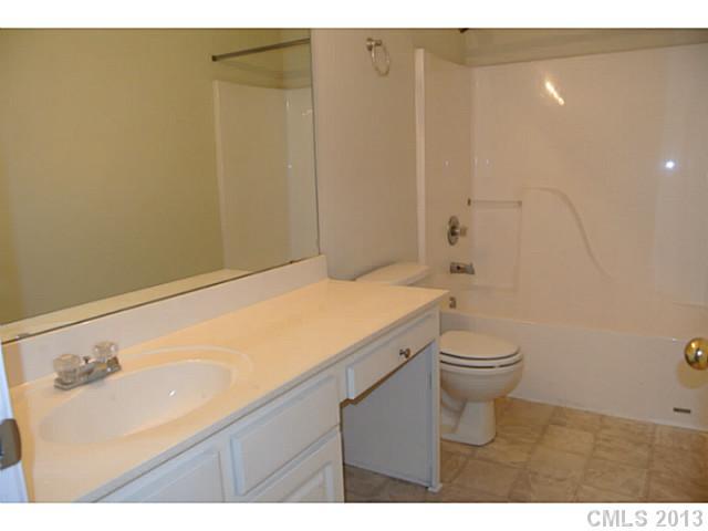 11406 Erwin Ridge Avenue Charlotte, NC 28213 - Photo 9 of 16 a bathroom with a sink a toilet and vanity