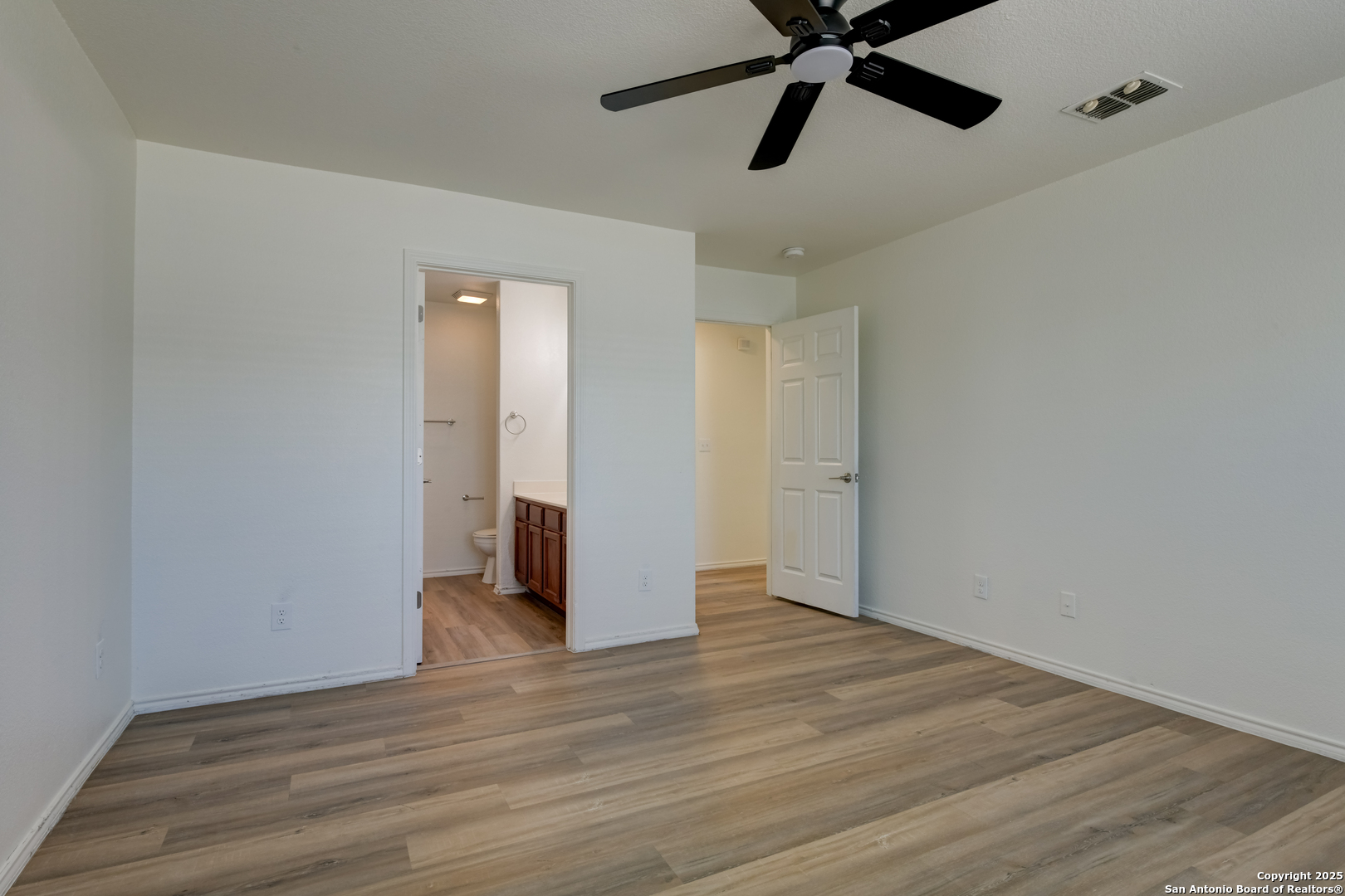 9447 Copper Mist Converse, TX 78109 - Photo 19 of 25 a view of an empty room and wooden floor