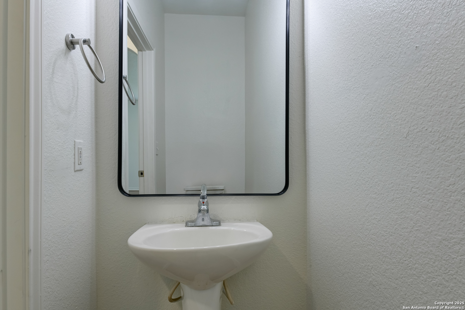9447 Copper Mist Converse, TX 78109 - Photo 8 of 25 a bathroom with a sink a toilet and mirror