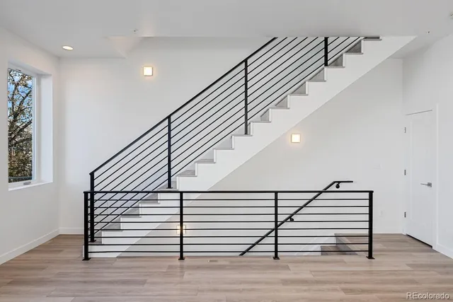 a view of entryway and hall with wooden floor
