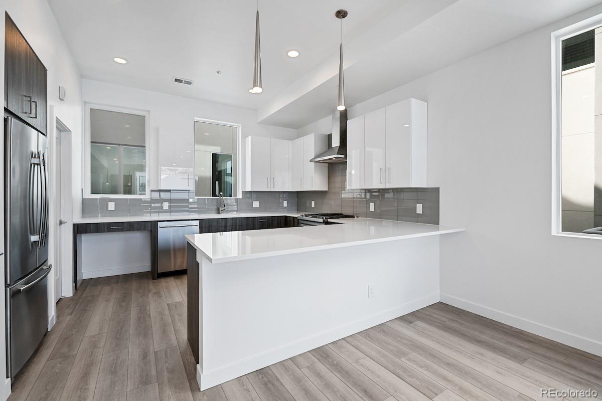 1624 Irving Street, Unit 1 Denver, CO 80204 - Photo 13 of 35 a kitchen with stainless steel appliances granite countertop a sink a stove and a refrigerator
