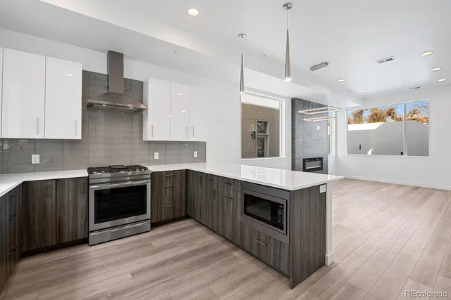 a kitchen with kitchen island a sink appliances and cabinets