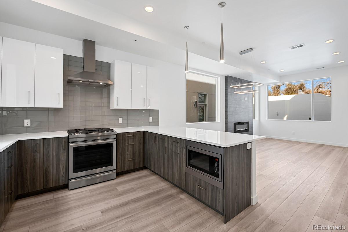 1624 Irving Street, Unit 1 Denver, CO 80204 - Photo 18 of 35 a kitchen with stainless steel appliances granite countertop a stove and a sink