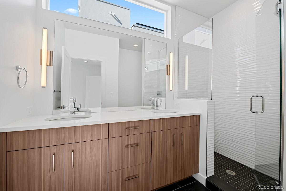 1624 Irving Street, Unit 1 Denver, CO 80204 - Photo 25 of 35 a bathroom with a double vanity sink and a mirror
