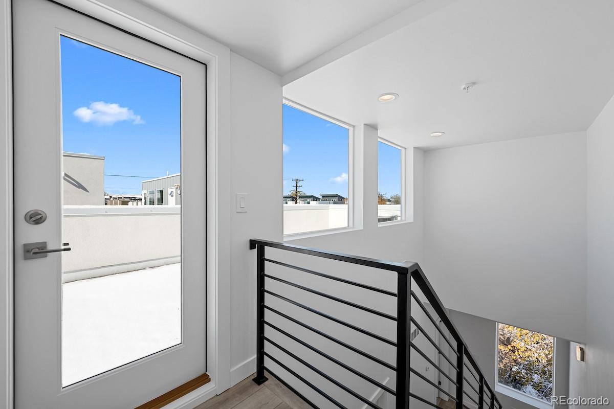 1624 Irving Street, Unit 1 Denver, CO 80204 - Photo 30 of 35 a view of a hallway with wooden floor and a bathroom