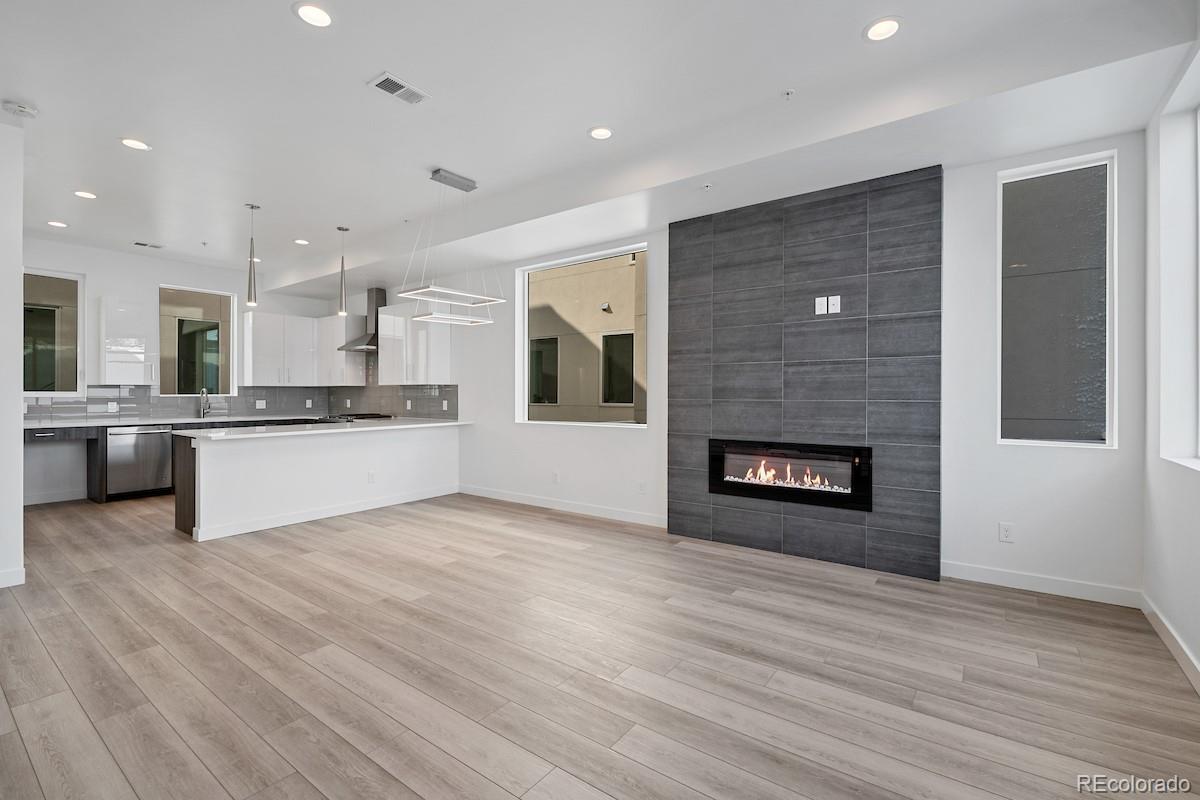 1624 Irving Street, Unit 1 Denver, CO 80204 - Photo 9 of 35 a view of a kitchen with a sink a fireplace and a window