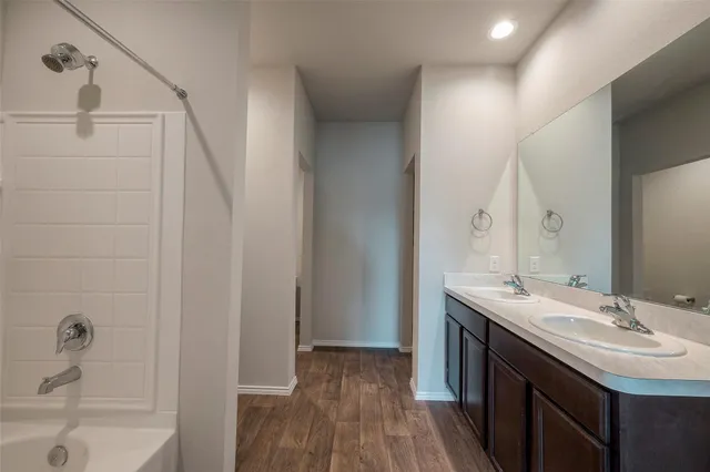 a bathroom with a sink a mirror and a bathtub