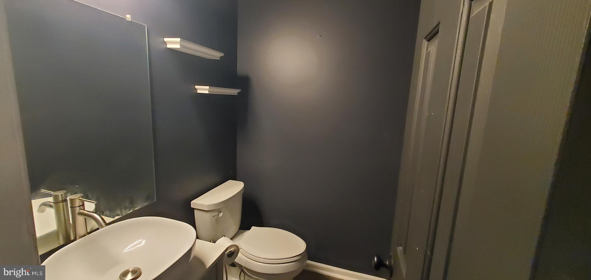 49 Villa Avenue Boyertown, PA 19512 - Photo 10 of 30 a white toilet sitting next to a bathroom sink and vanity