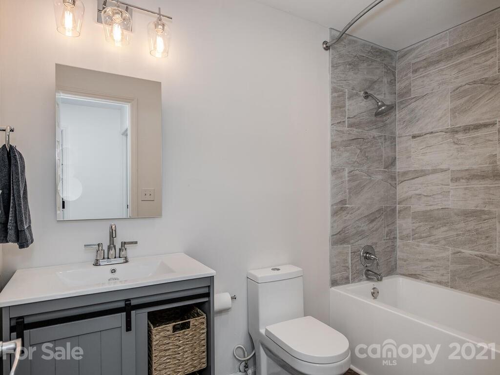 5024 Rea Road Charlotte, NC 28226 - Photo 14 of 19 a bathroom with a sink a toilet and shower
