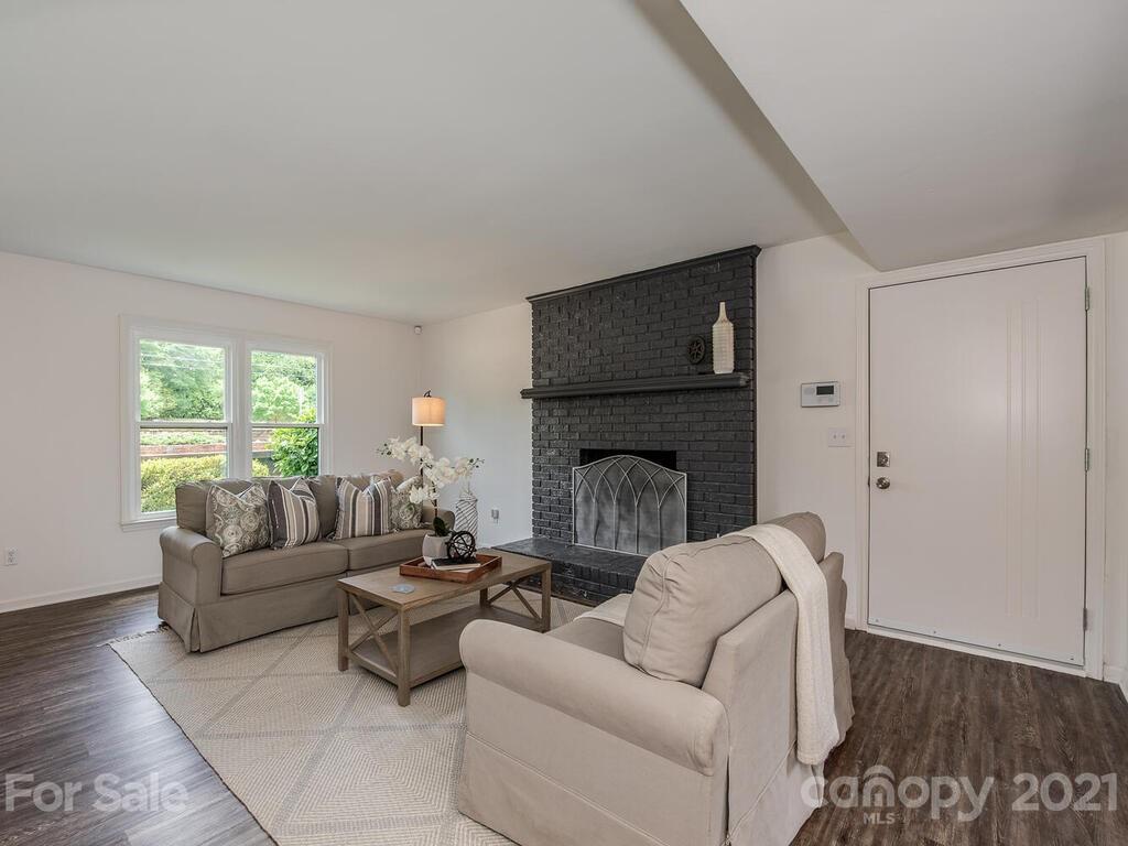 5024 Rea Road Charlotte, NC 28226 - Photo 4 of 19 a living room with furniture a window and a fireplace