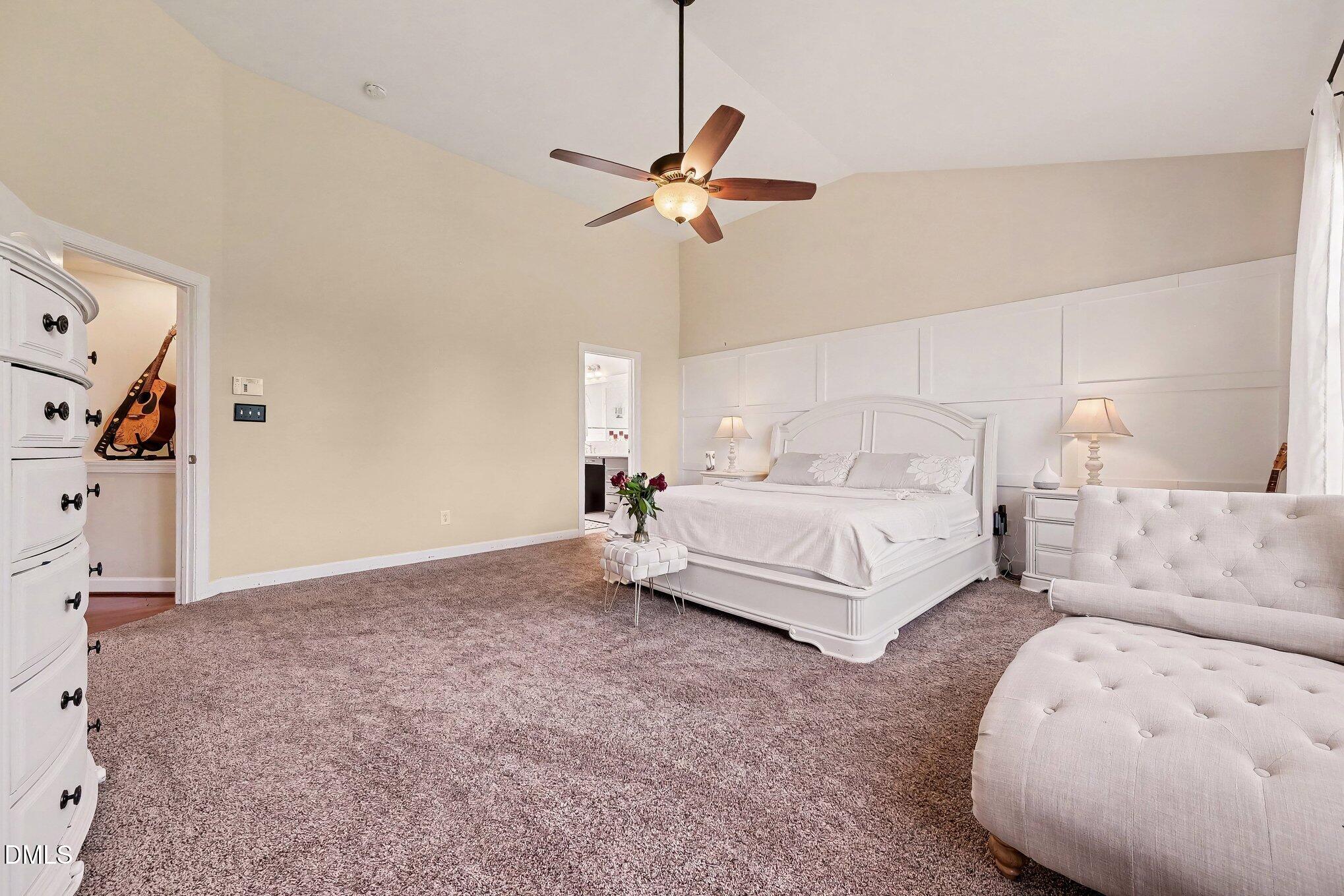 4000 Banks Stone Drive Raleigh, NC 27603 - Photo 23 of 60 a bedroom with a bed and a chandelier