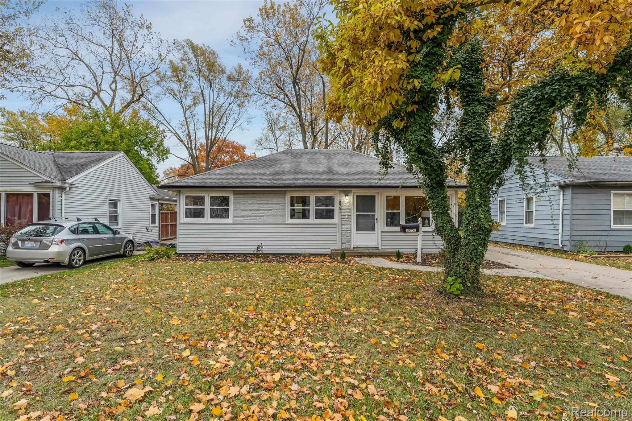 15751 West 14 Mile Road Franklin, MI 48025 - Photo 24 of 25 Siding exterior with a covered entry, multiple front-facing windows, and a paved driveway