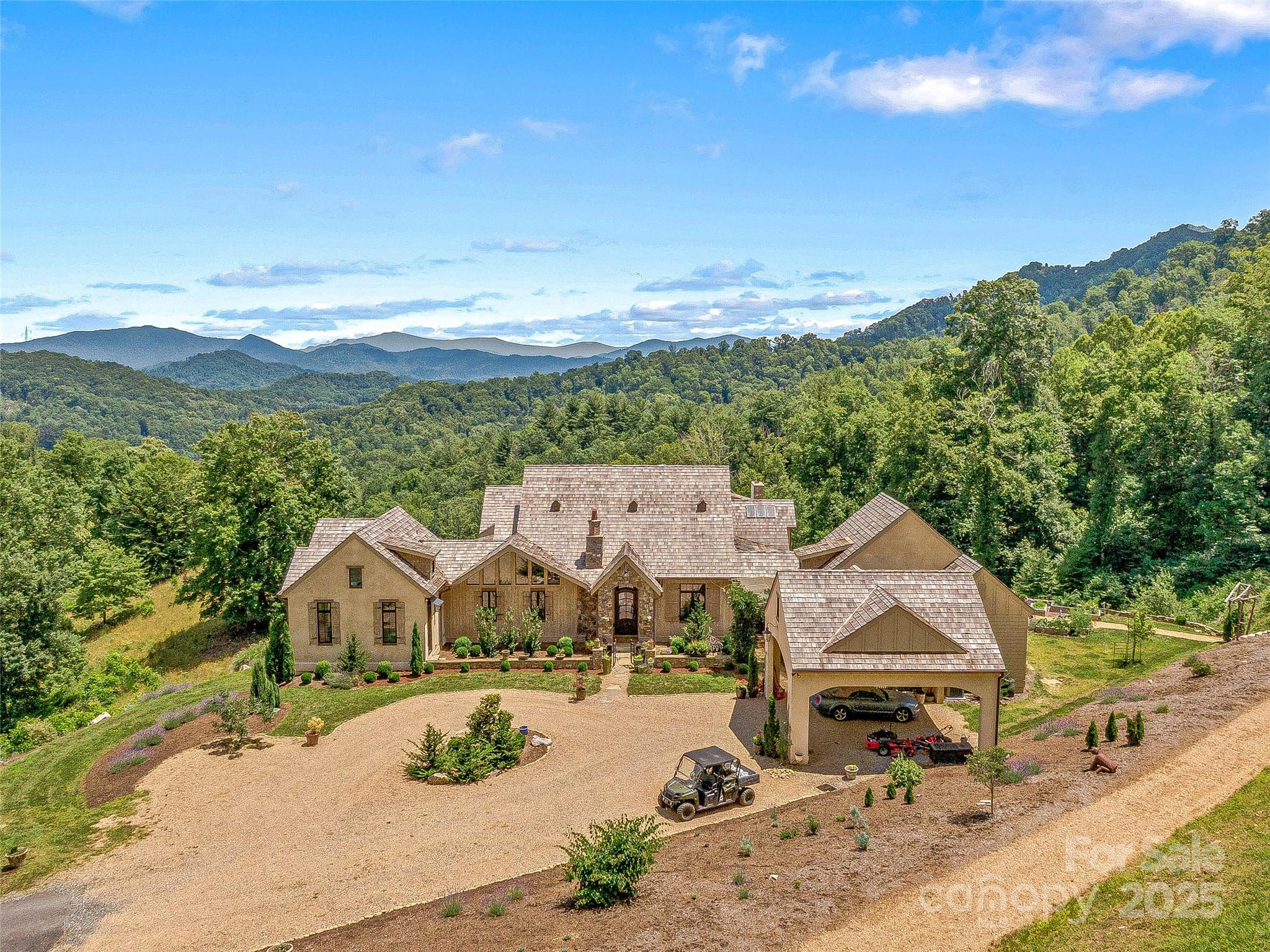 an aerial view of a house with garden space and ocean view