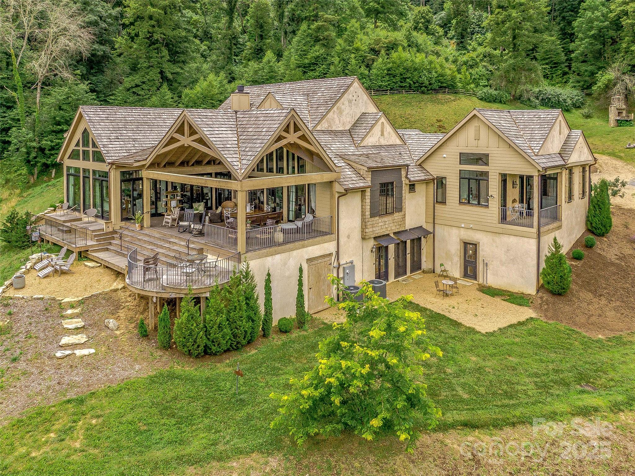 384 Doan Town Road Burnsville, NC 28714 - Photo 12 of 44 a view of a big house with a big yard and potted plants