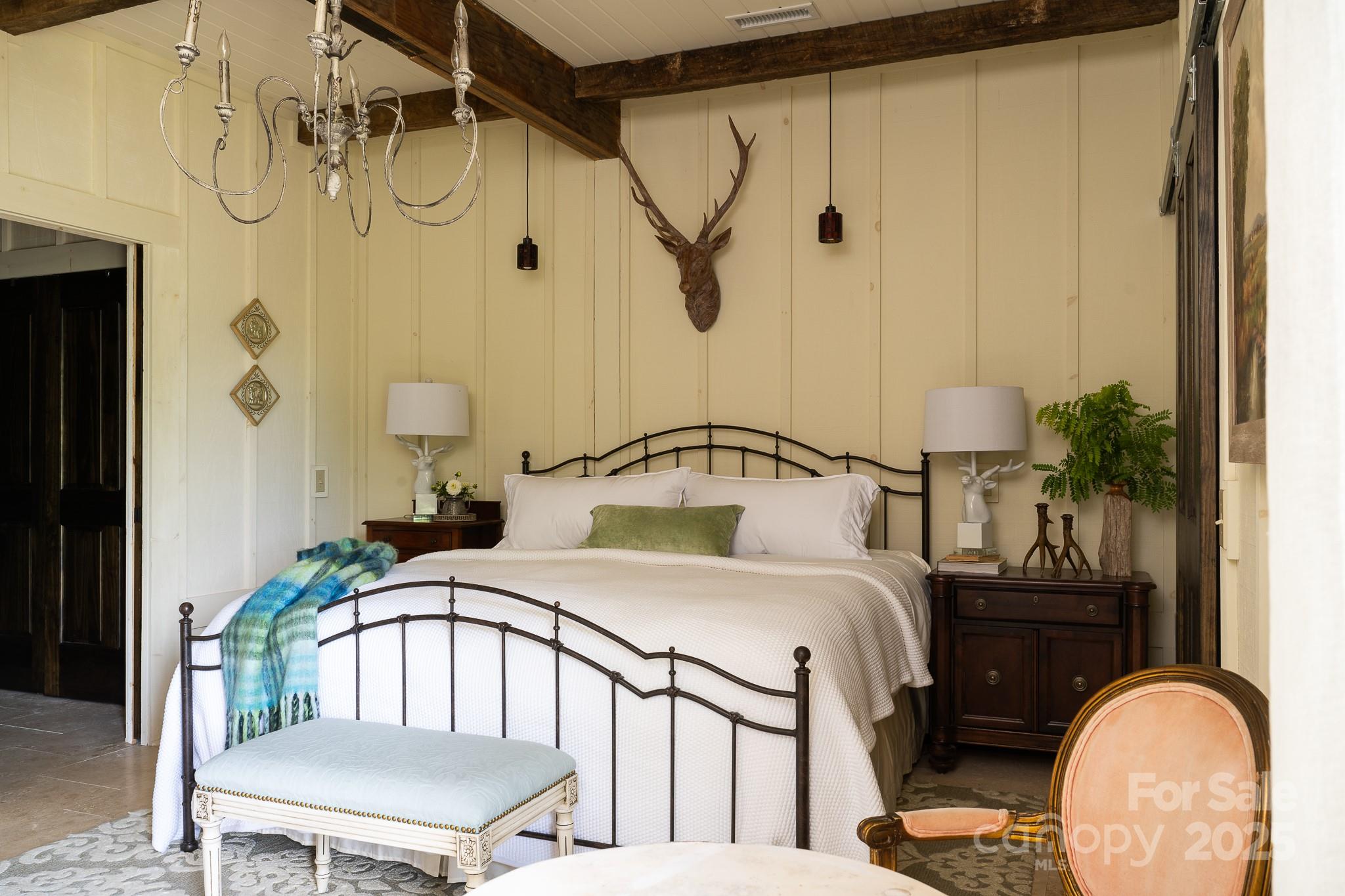 384 Doan Town Road Burnsville, NC 28714 - Photo 37 of 44 a bedroom with a bed table and a mirror