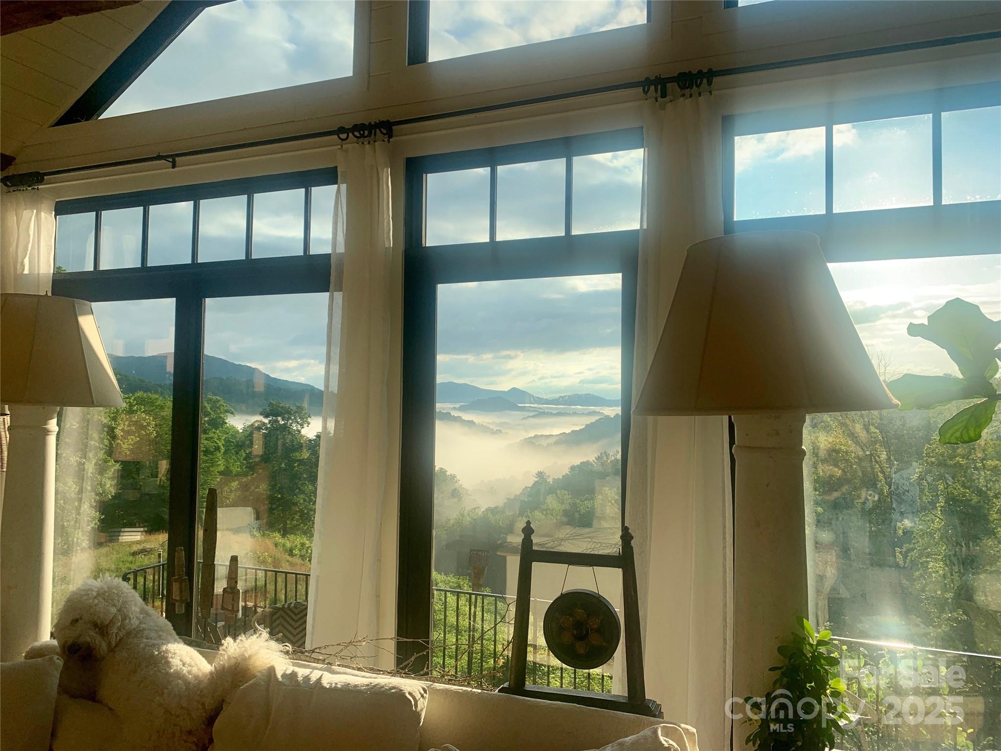 384 Doan Town Road Burnsville, NC 28714 - Photo 42 of 44 a living room filled with furniture and a floor to ceiling window