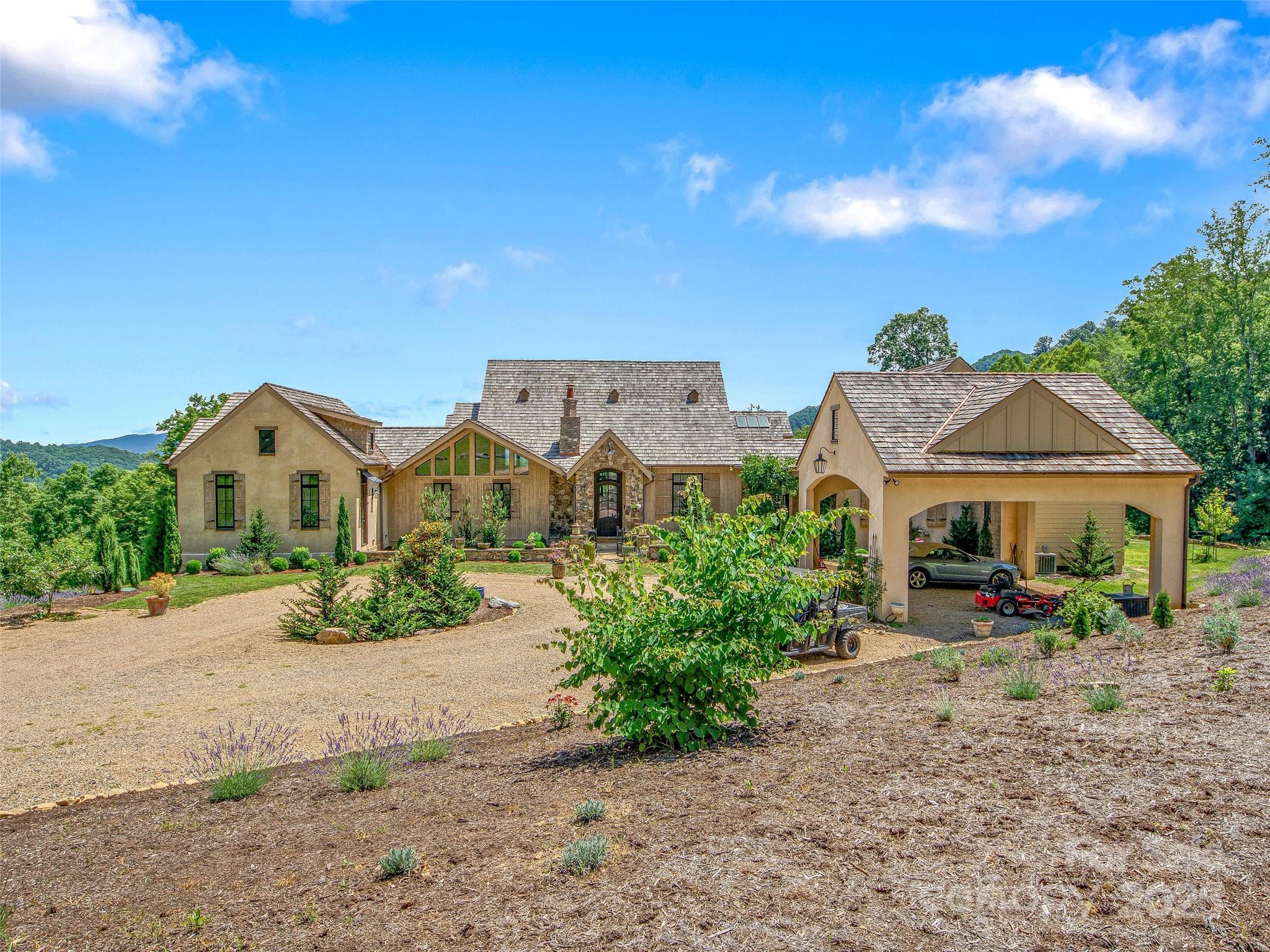 384 Doan Town Road Burnsville, NC 28714 - Photo 6 of 44 a front view of a house with garden