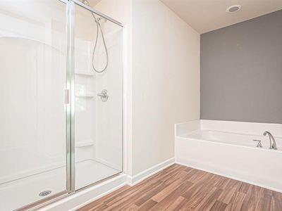 145 Townview Drive Woodstock, GA 30189 - Photo 13 of 21 a bathroom with a bathtub and a shower