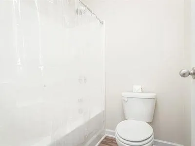 a view of a house with a door and wooden walls