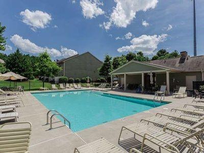 145 Townview Drive Woodstock, GA 30189 - Photo 21 of 21 a front view of a house with swimming pool garden and outdoor seating