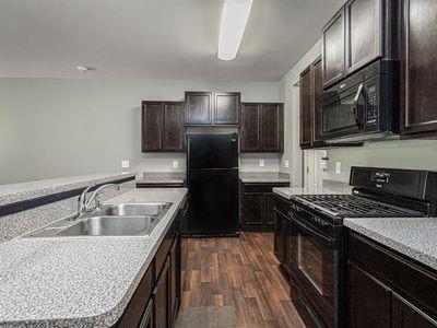 145 Townview Drive Woodstock, GA 30189 - Photo 5 of 21 a kitchen with granite countertop stainless steel appliances a sink stove and refrigerator