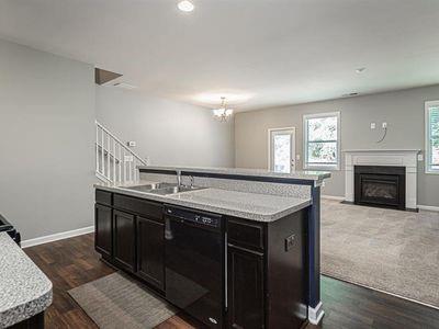 145 Townview Drive Woodstock, GA 30189 - Photo 7 of 21 a kitchen with a stove and a wooden floors