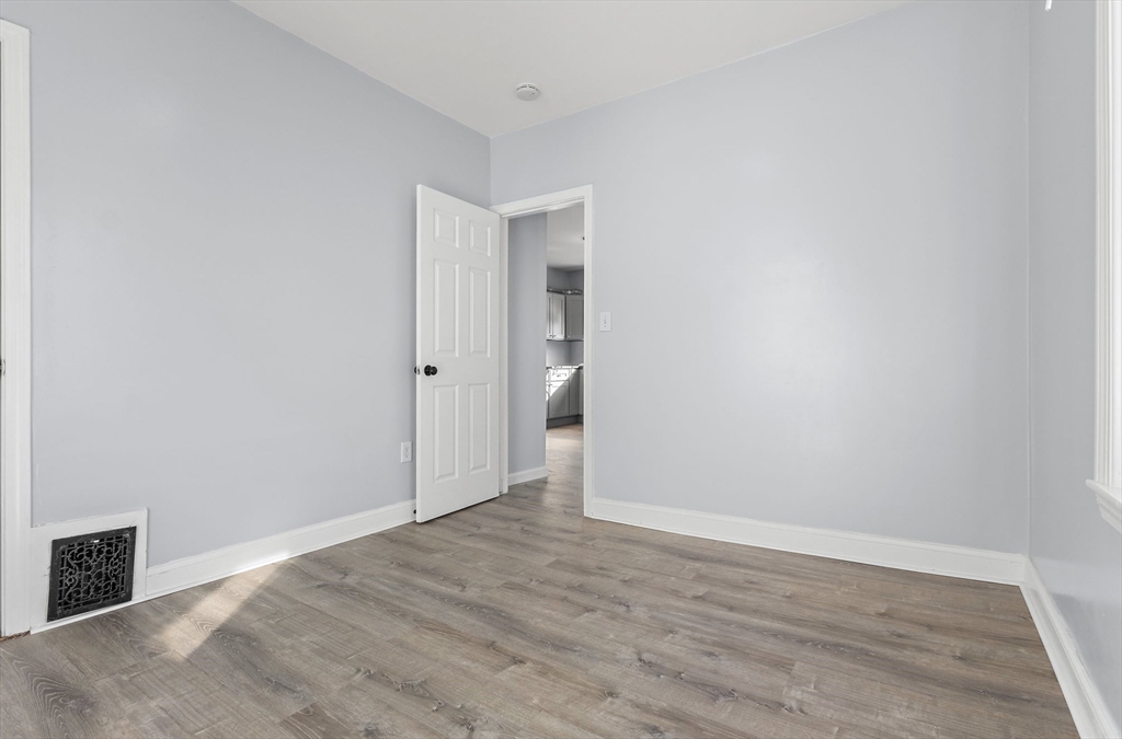 403 Ferry Street, Unit 2 Malden, MA 02148 - Photo 12 of 17 a view of an empty room with wooden floor and closet