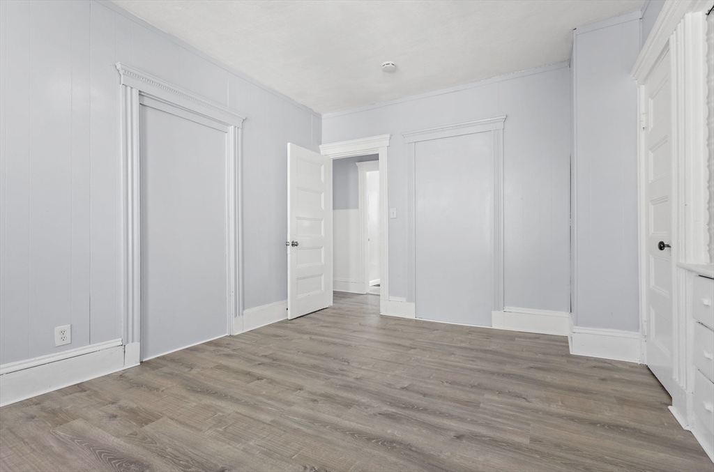 403 Ferry Street, Unit 2 Malden, MA 02148 - Photo 14 of 17 a view of an empty room with wooden floor