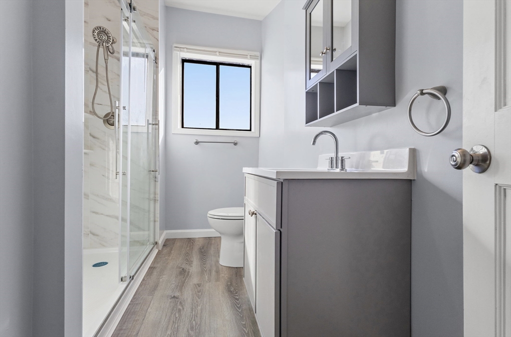 403 Ferry Street, Unit 2 Malden, MA 02148 - Photo 7 of 17 a bathroom with a sink a toilet and shower