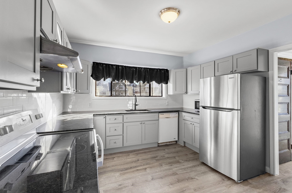 403 Ferry Street, Unit 2 Malden, MA 02148 - Photo 8 of 17 a kitchen with a sink appliances and cabinets