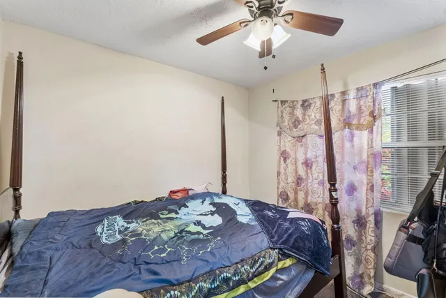 a bed sitting in a bedroom next to a window