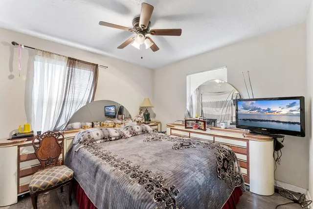 a bedroom with a bed and a flat screen tv